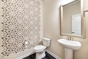 Contemporary bathroom featuring a geometric patterned wall and elegant fixtures.